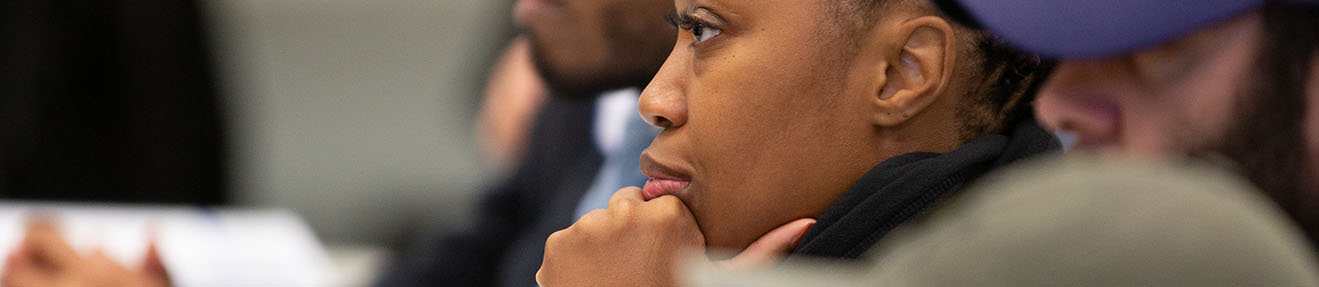 A group of people listen and contemplate training.